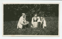 Photographie d'Ignace Obuchowicz (filleul de Paderewski) en costume traditionnel polonais dans le parc de Riond-Bosson, assis en compagnie d'Anne Strakacz (fille de Sylwin, secrétaire de Paderewski) et de Loulou (Lulusia) Dolézal (fille du jardinier), en 1